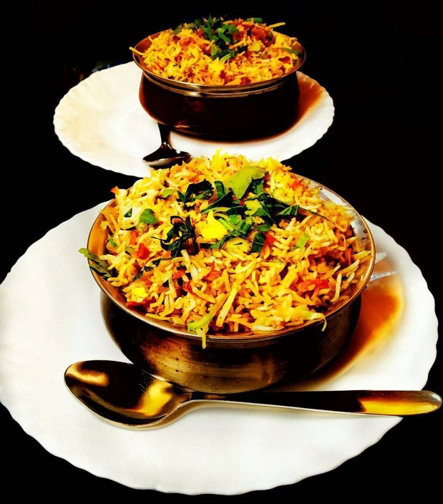 colorful chicken biryani in traditional pot