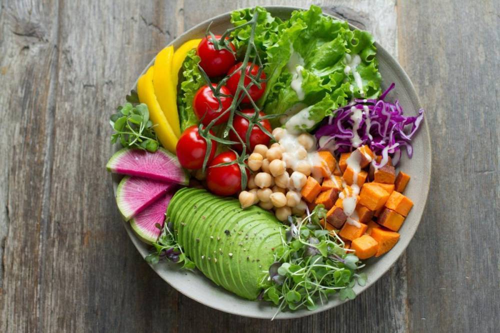 colorful fresh vegetable salad in white bowl